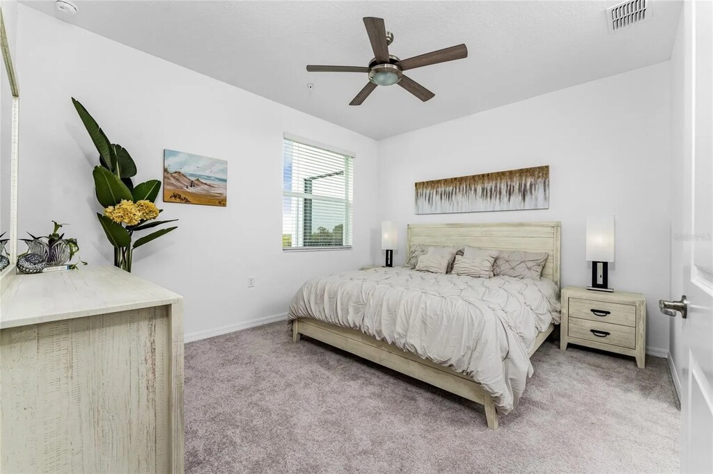 Primary bedroom with king bed and attached bathroom