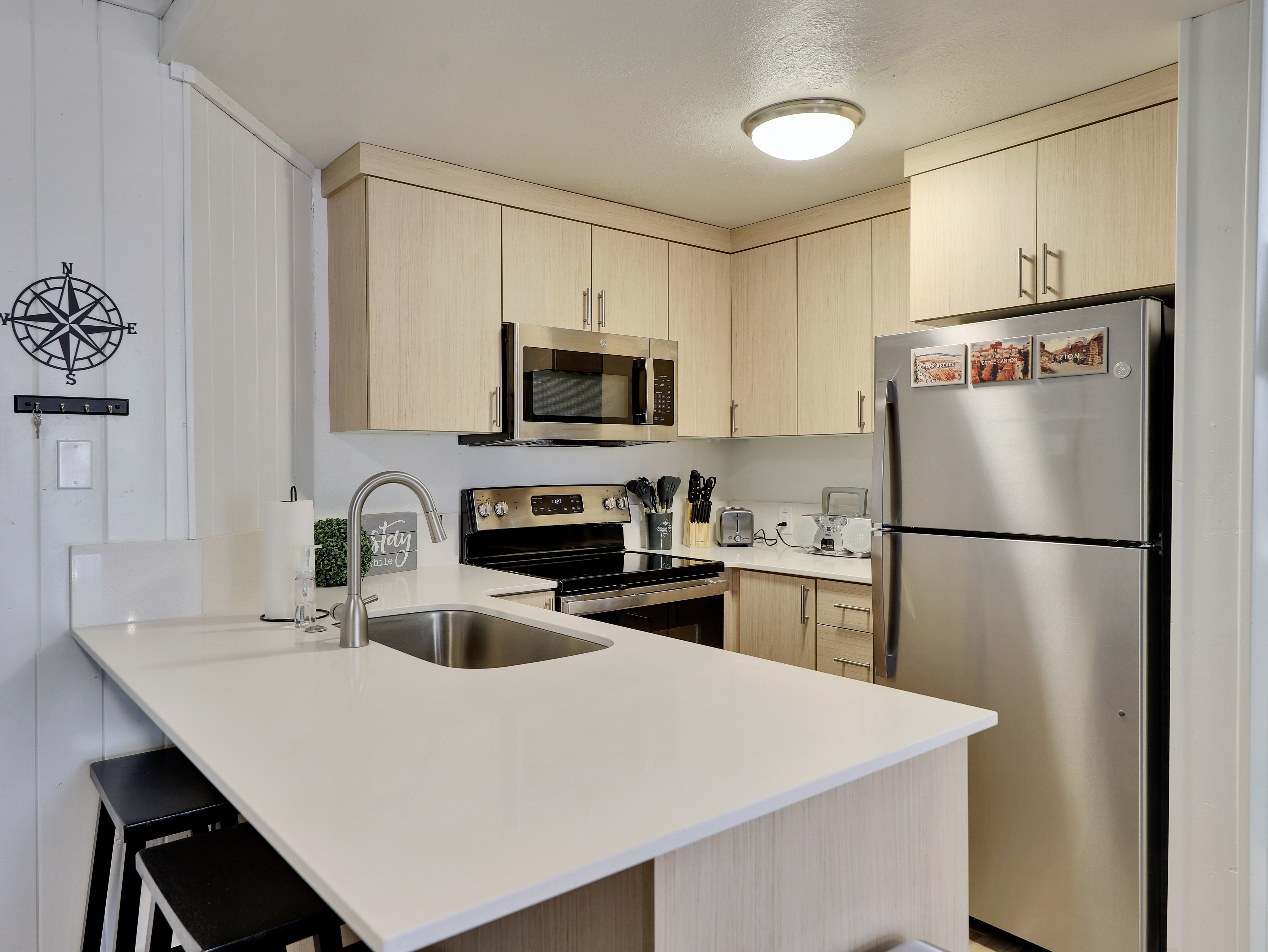 View of the newly upgraded kitchen featuring brand-new appliances, a Keurig coffee machine, toaster, dishwasher, and all the cooking essentials to make your stay comfortable and memorable.