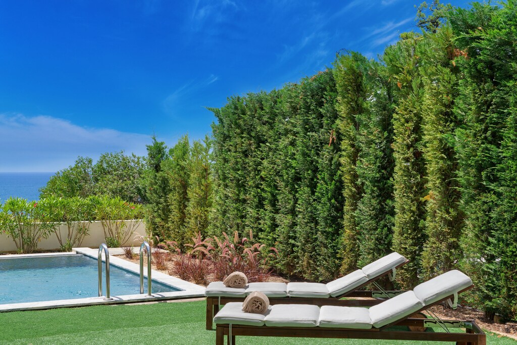 Pool area with sun loungers for relaxation