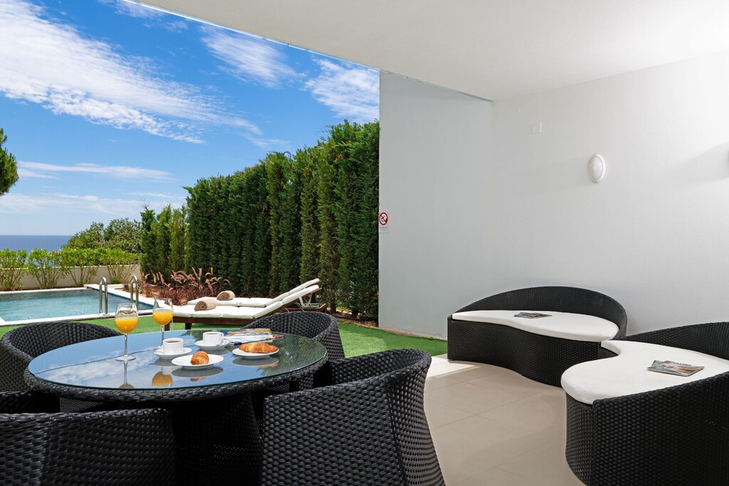 Terrace by the pool with outdoor seating