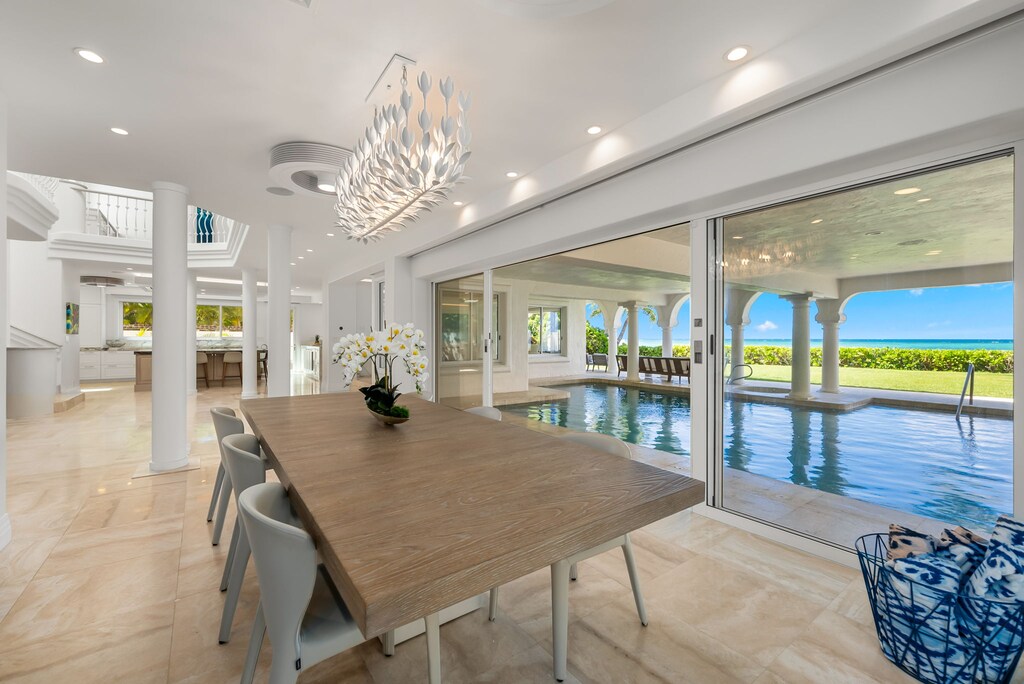 Elegant dining space with seating for eight and direct access to the poolside lanai—perfect for island-style dinners.