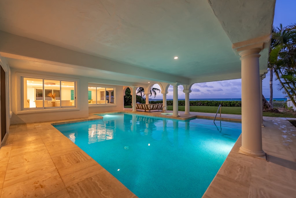 Evenings are made magical in this serene covered pool, ideal for both relaxation and play.
