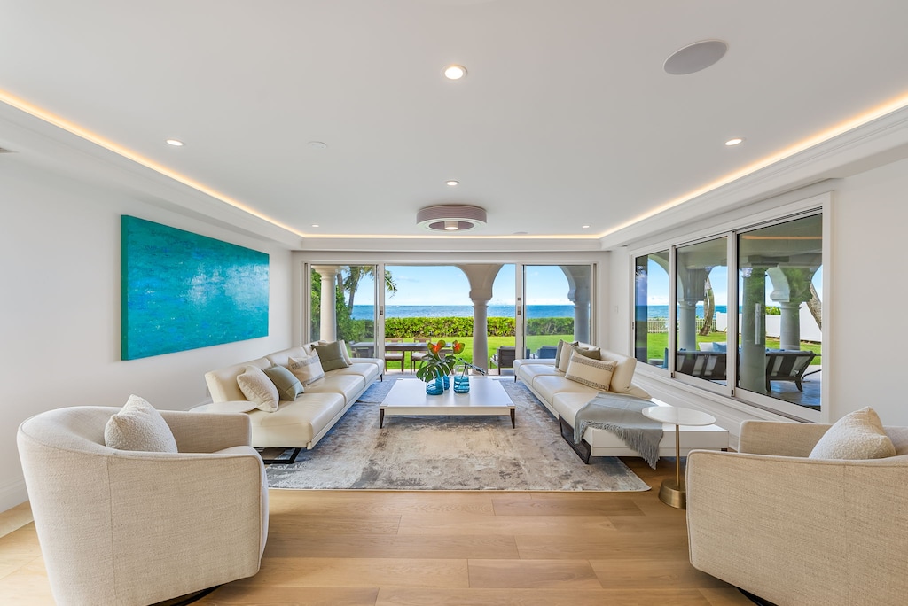 Expansive living room with panoramic ocean views, perfect for gathering, lounging, or entertaining in style.