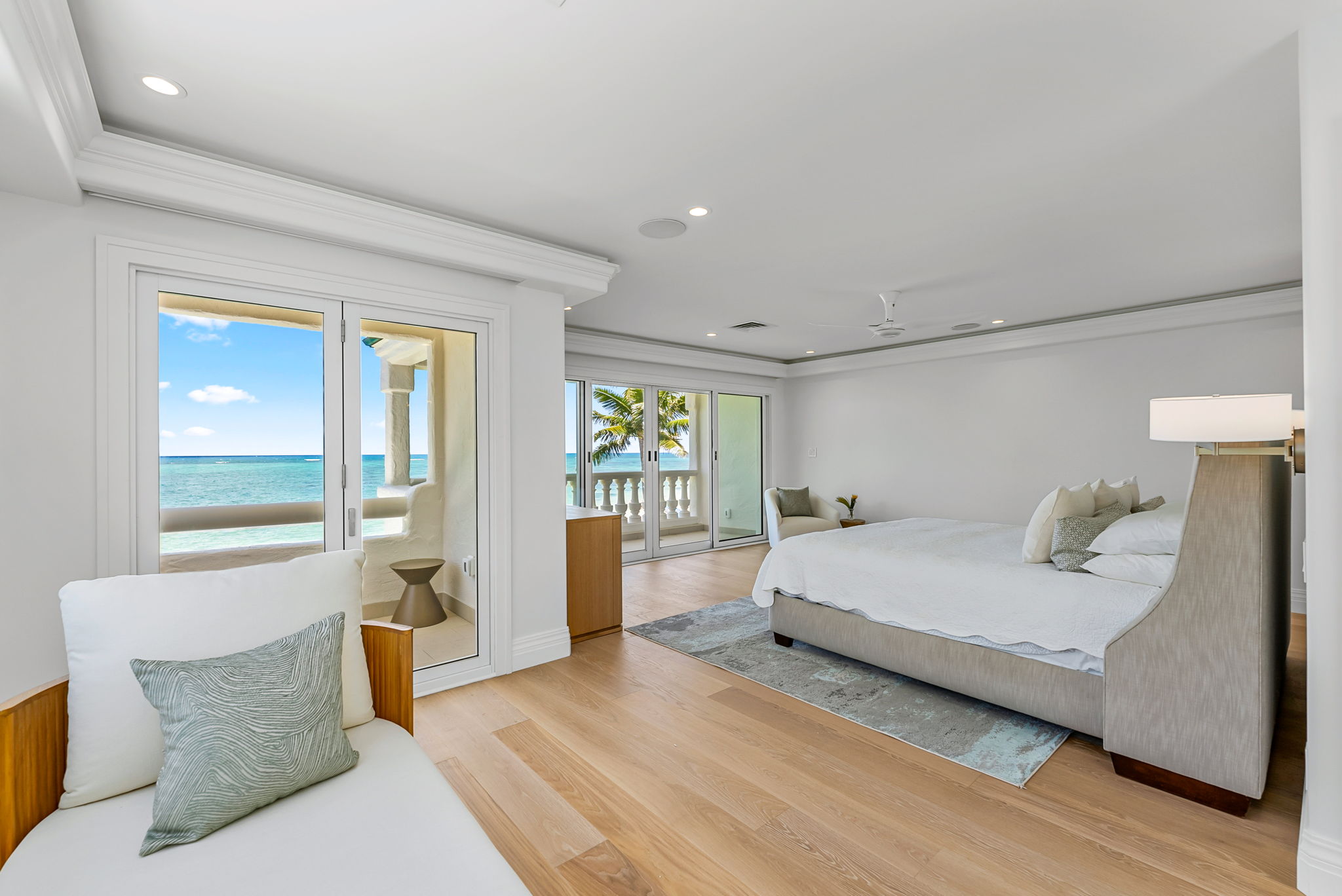 Wake up to panoramic ocean views in this serene primary suite with king bed and private lanais.