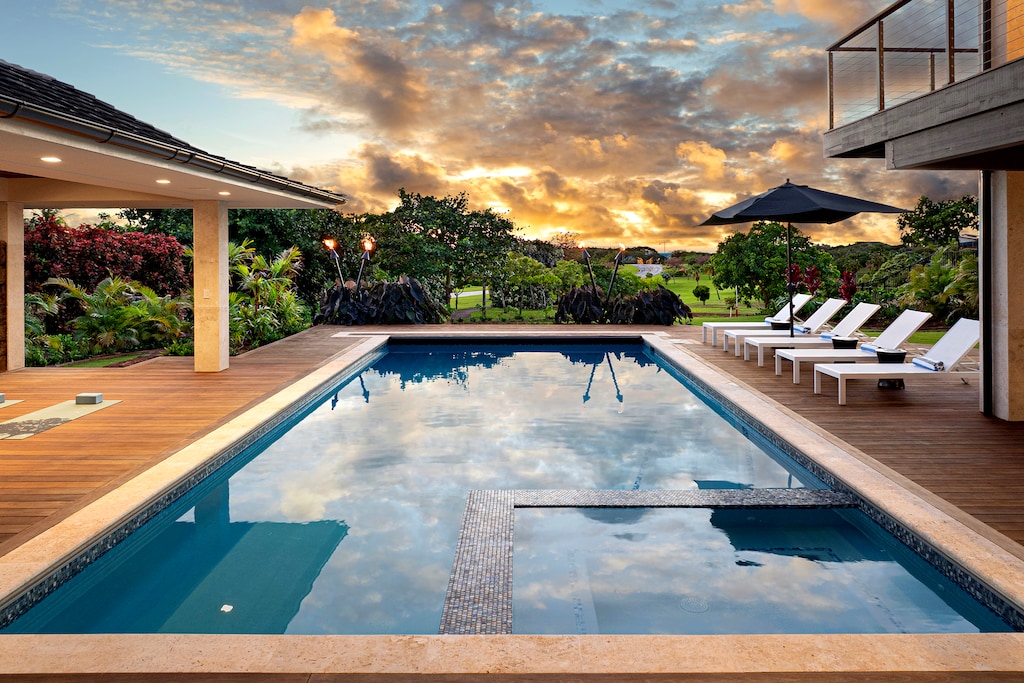 Enjoy a tranquil swim in the sparkling pool surrounded by lush greenery and stunning sunsets.