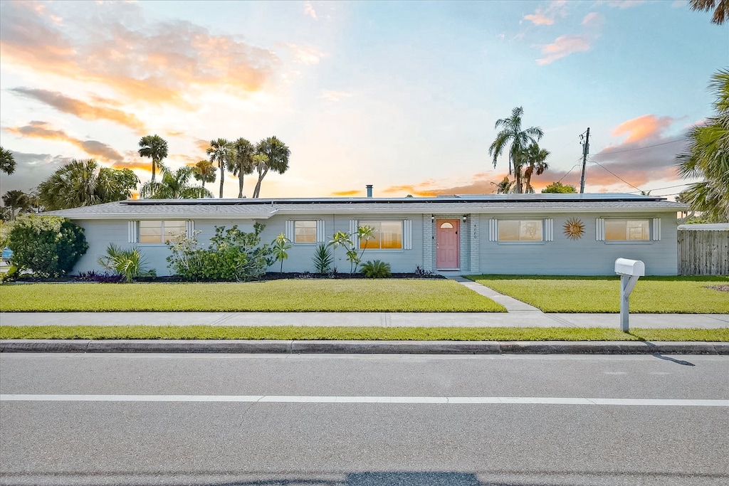 Charming coastal home with lush lawn & sunset views for a serene vibe.