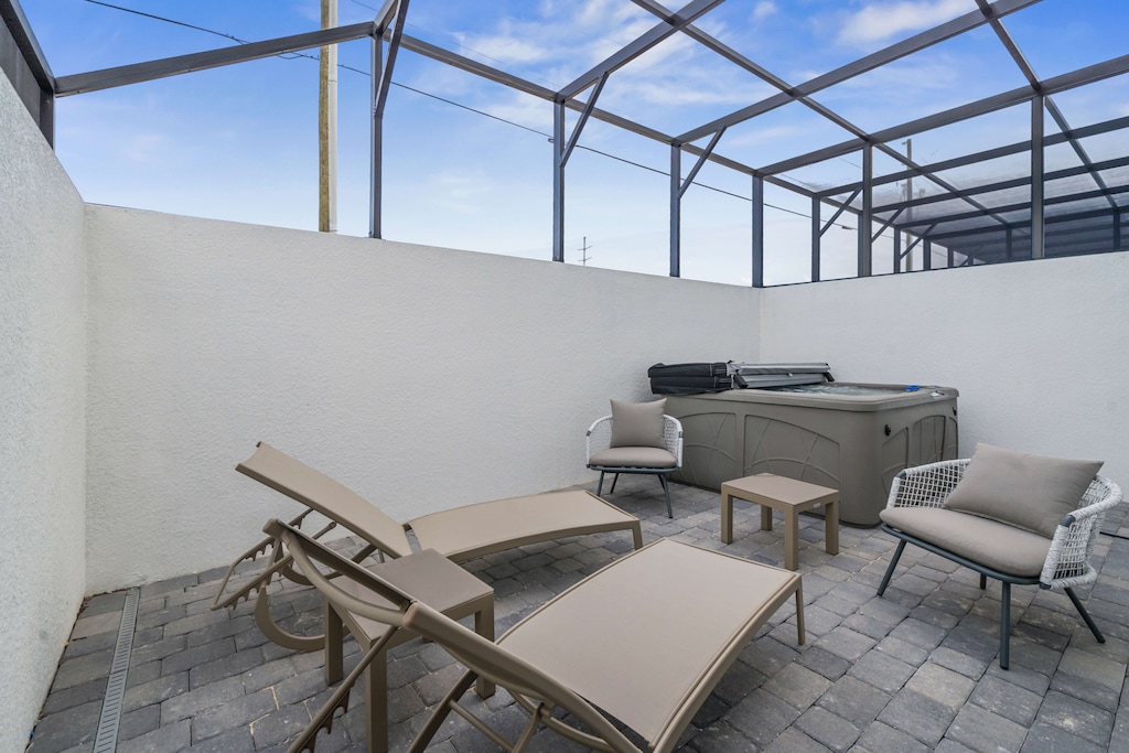 Relax and recharge in this private outdoor space featuring comfortable loungers and a hot tub - Perfect for sunbathing by day or stargazing by night, all in a peaceful setting - A serene retreat to create lasting memories with family and friends