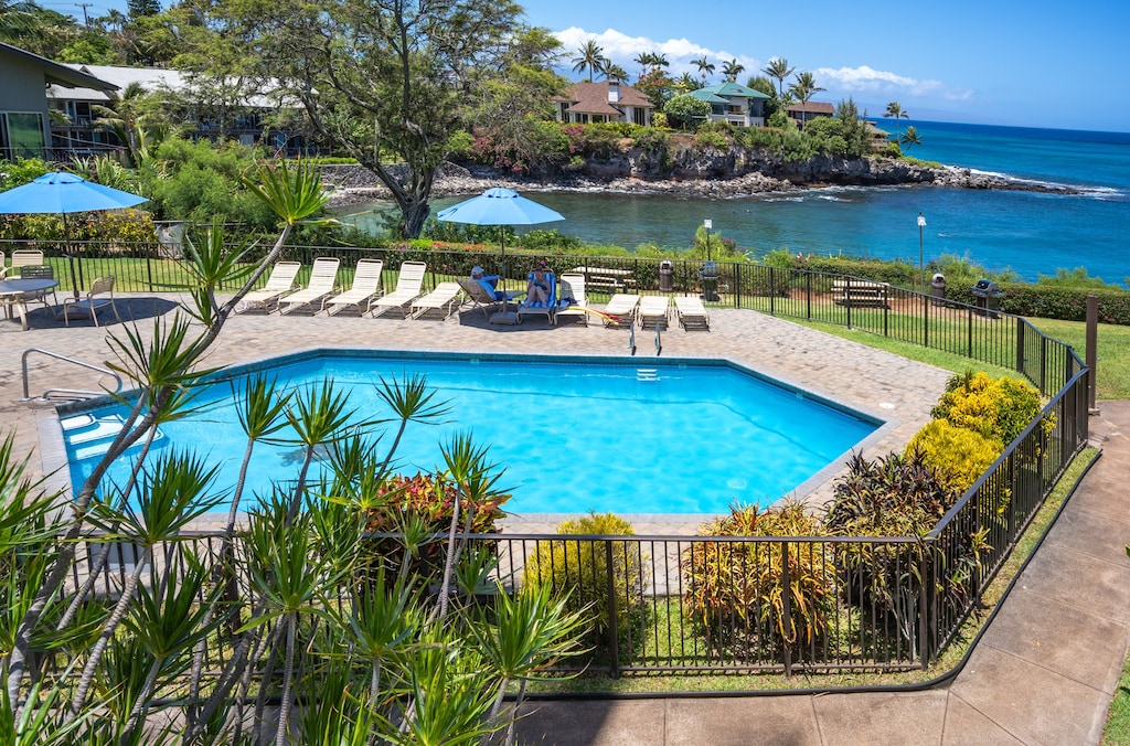 Pool on property with an ocean view