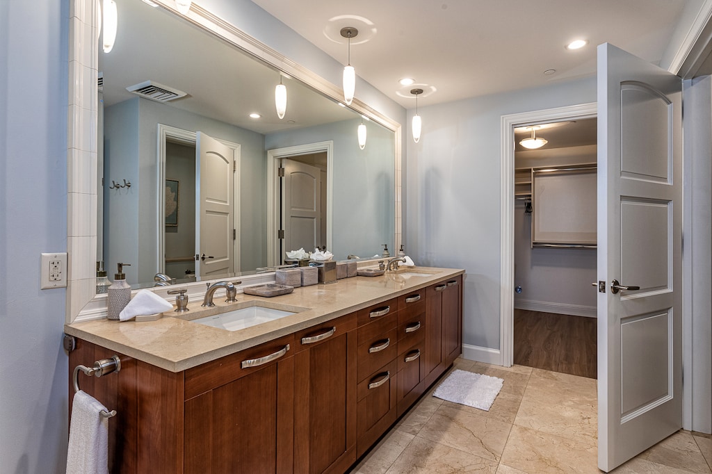 Primary bathroom with a walk in closet and a water closet.