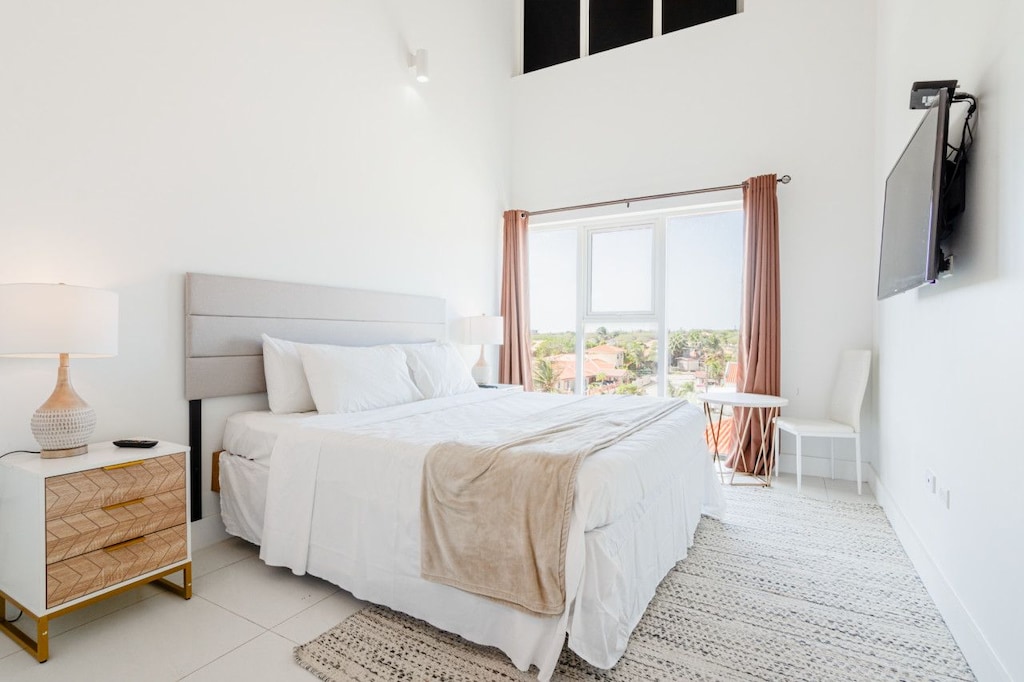 Start your day with stunning views and sunshine pouring into this inviting bedroom - Plush king size bed with soft linens for a restful night and wake up recharged - A serene retreat that blends comfort and style, perfect for unwinding in paradise