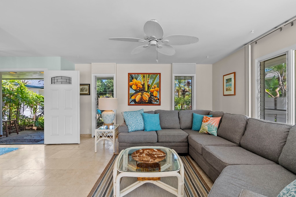 Relax in this inviting living space, where soft tones and tropical artwork create the perfect island retreat ambiance.
