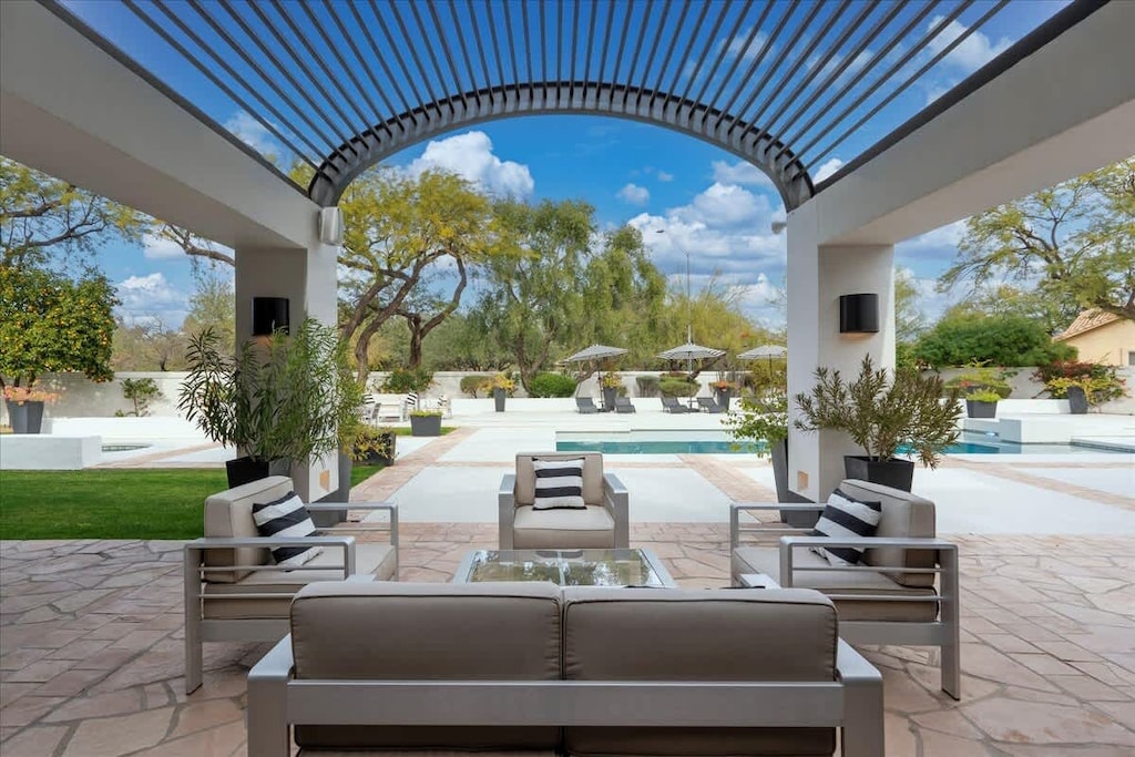 
Shaded outdoor lounge with comfortable seating and direct pool access