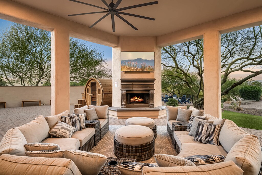 Outdoor hangout zone: fire, screen, and group seating.