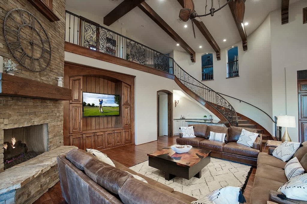 Open-concept living with soaring ceilings and game room loft above