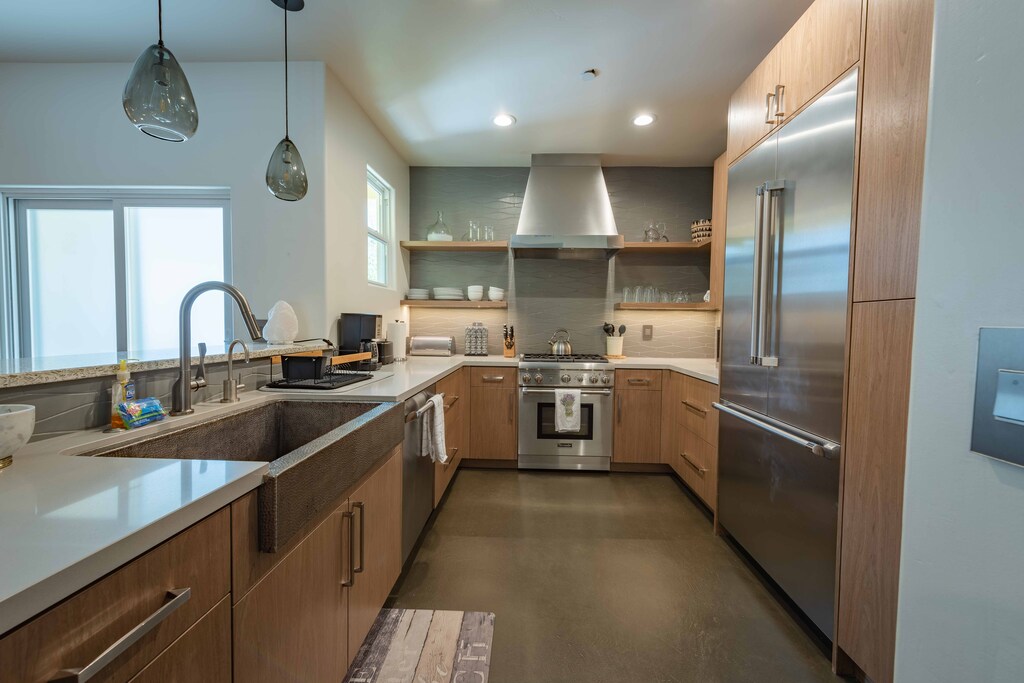 Clean kitchen offering high-end stainless steel appliances