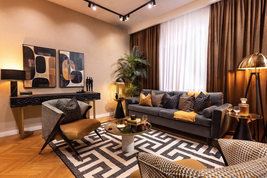 Gold, black, and greenery adorn our luxurious living space. Your retreat awaits. ✨🌿🖤