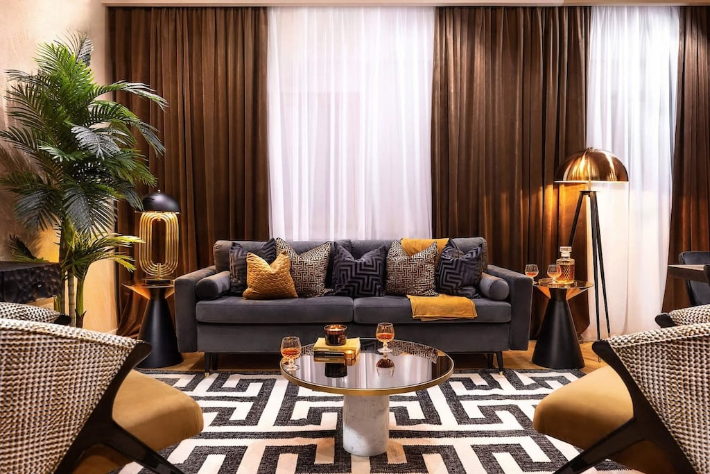 Luxury living: modern design, gold highlights, black, and lush plants. Your stylish escape. ✨🌿🖤