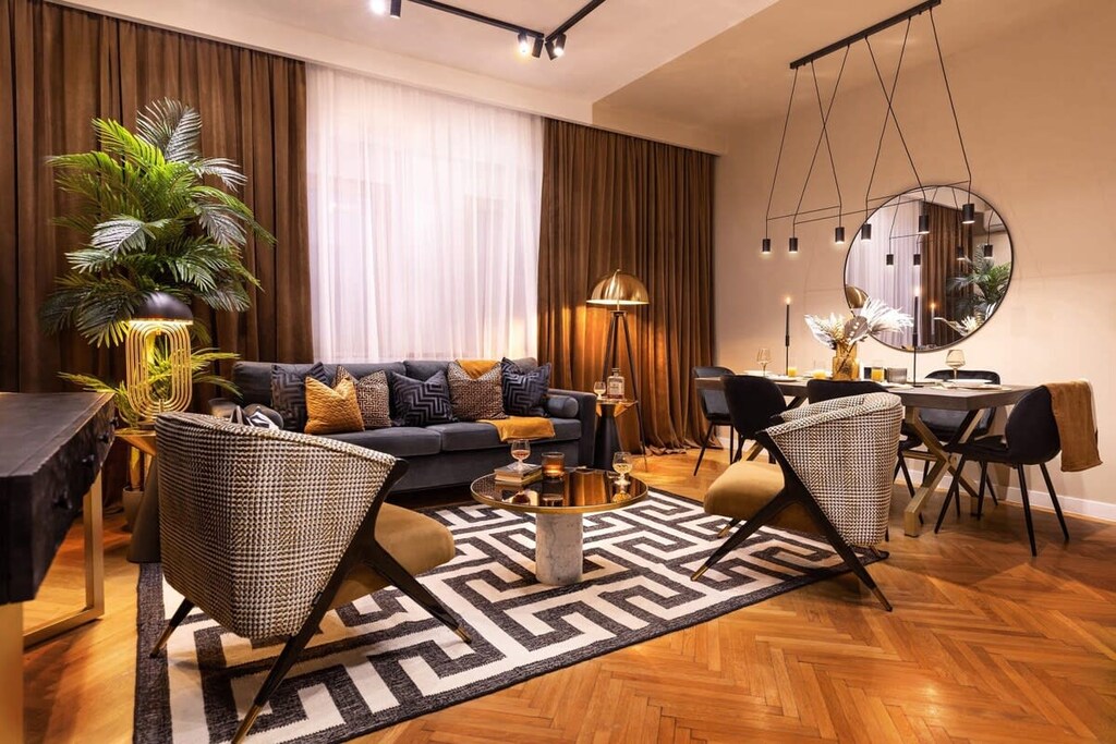 A fusion of gold, noir, and lush greens creates a sumptuous living space. Welcome to luxury.