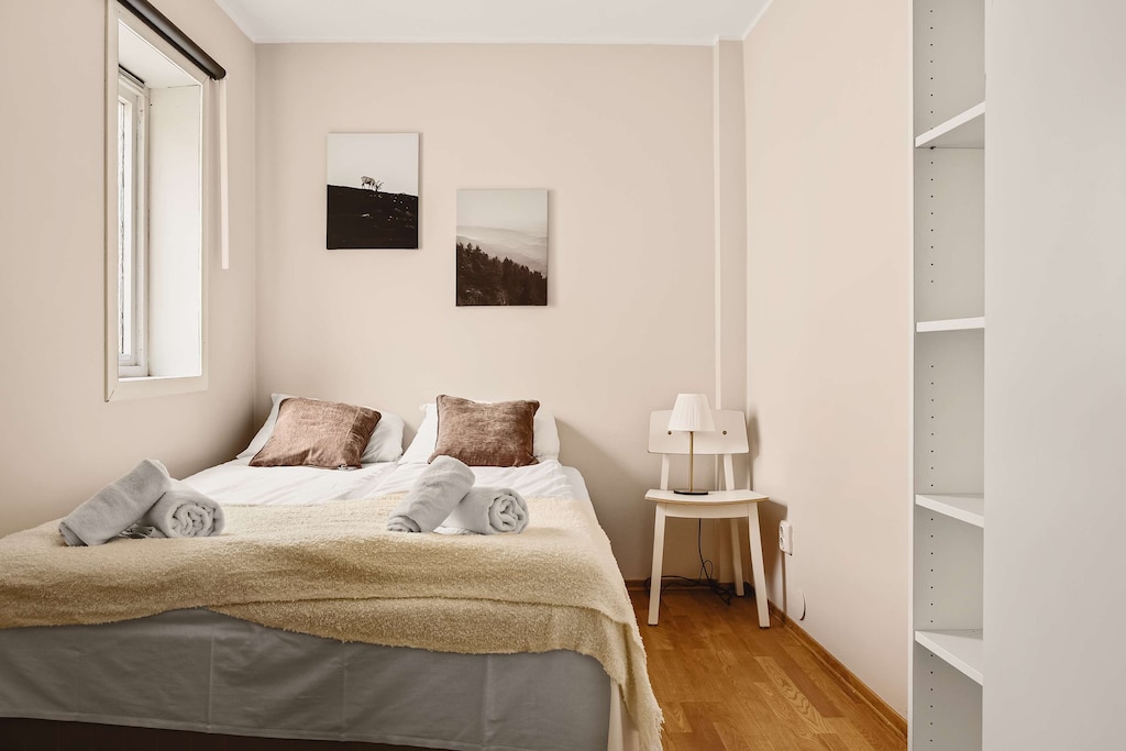 Bright and cozy bedroom with soft bedding and natural light, creating a serene atmosphere.