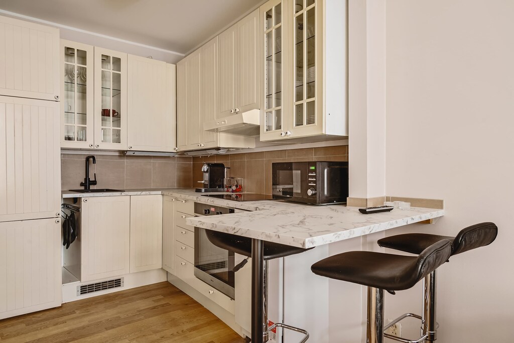 Sleek and functional kitchen featuring contemporary finishes and a welcoming dining space.