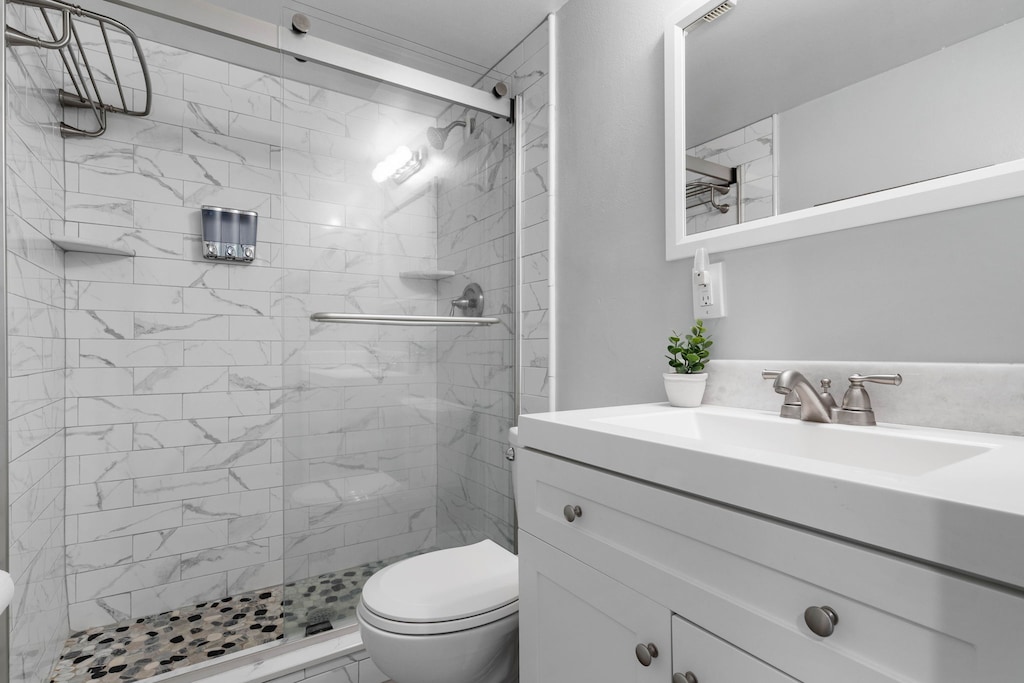Sleek bathroom with a glass shower, spa-like tile, and a fresh vanity for a touch of luxury.