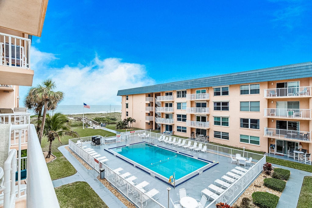 Enjoy the heated pool with ocean vibes, surrounded by sun loungers and tropical greenery.