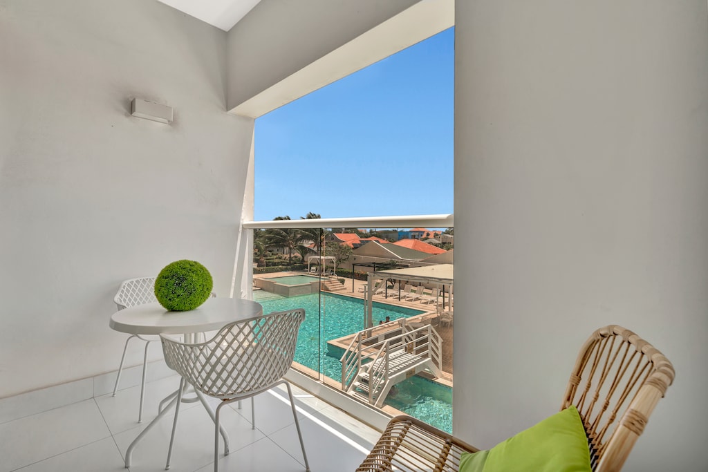 Wake up to ocean breezes and poolside views from your private balcony escape - Sip your morning coffee or evening cocktail while soaking in the vibrant scenery - The perfect spot to relax, recharge, and embrace the ultimate vacation vibes