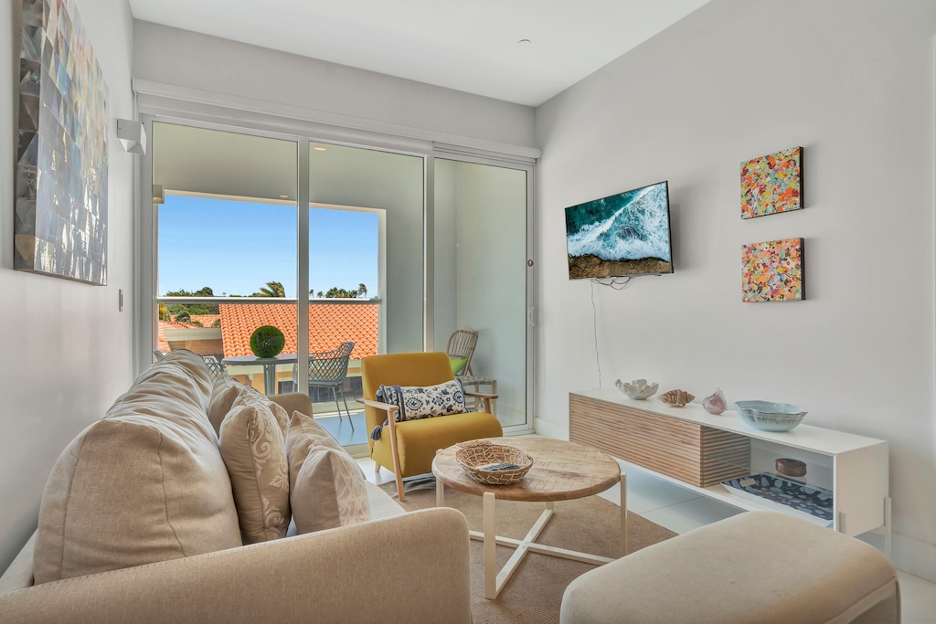 Sink into the inviting couch, unwind, and let the vacation vibes take over - Natural light pours in through the sliding doors, connecting you to the outdoors - Step onto the private balcony for fresh air, stunning views, and ultimate relaxation