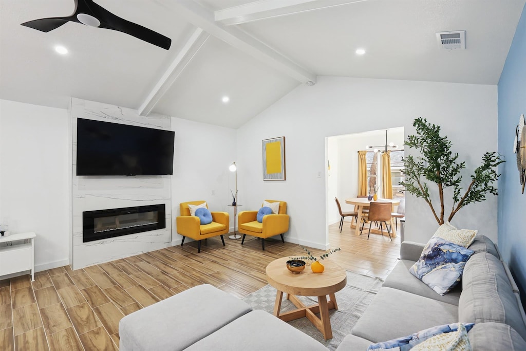 With cheerful pops of color, elegant vaulted ceilings, and stylish furniture that invites you to sit and stay for a while, this living room is perfect for casual hang-outs and catch-up conversations!