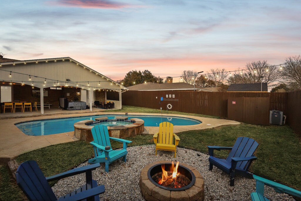 Grab a seat on one of these colorful lawn chairs and gather around the cozy fire pit as you stay nice and warm, chatting late into the night under the starry night sky.