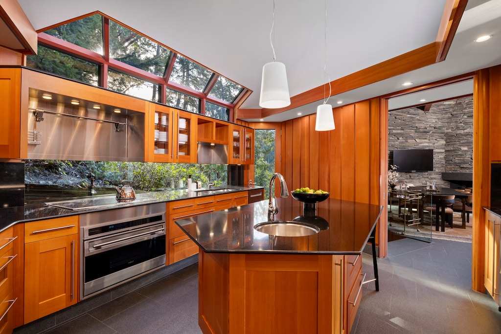 Modern kitchen with a central island and skylight for natural brightness.