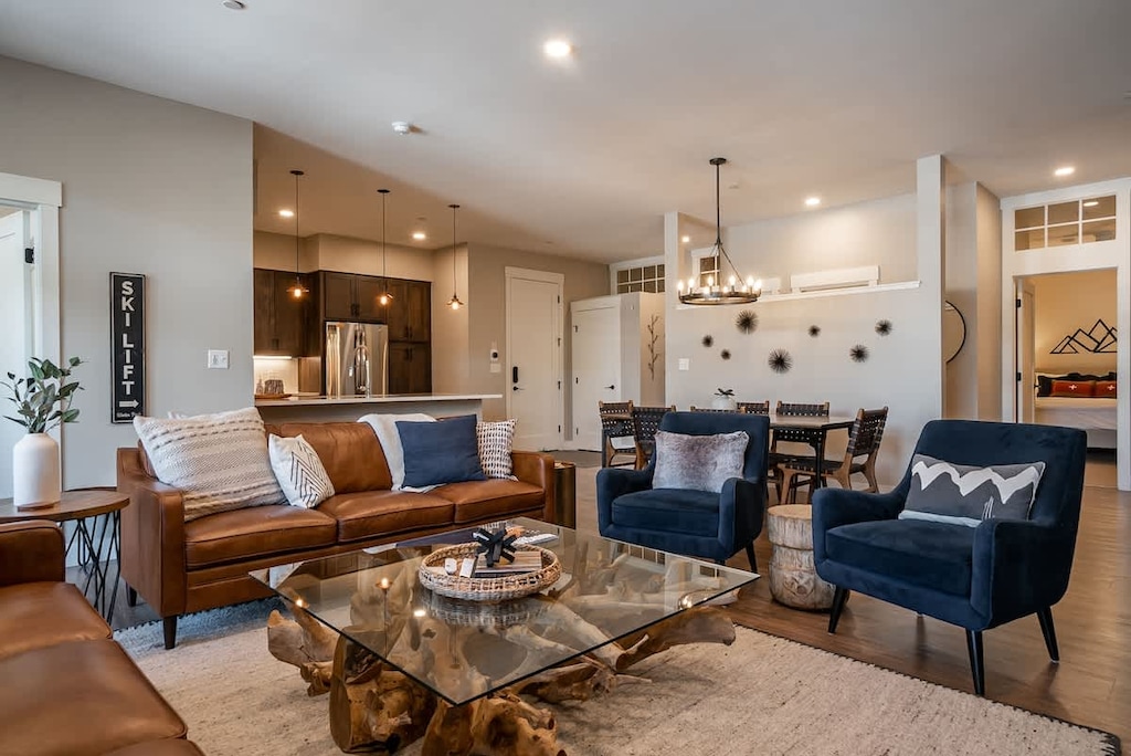 Spacious open-concept layout with cozy seating, modern decor, and easy flow to the dining area and kitchen—perfect for families, friends, and entertaining during your short-term stay.
