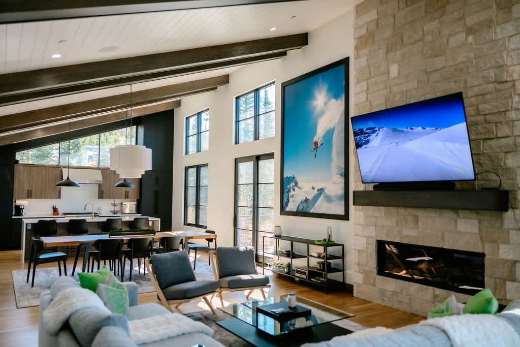 - Cozy up by the fireplace in this stylish, open-concept living room, perfect for relaxing after a day of adventure. This bright and spacious area is designed for both entertaining and unwinding.