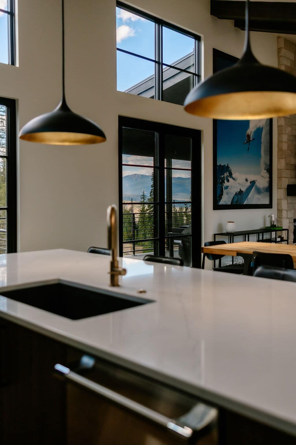 - Cook a delicious meal with a stunning view of the mountains, visible through the large windows and glass doors. This kitchen is a beautiful blend of sleek design and natural scenery.