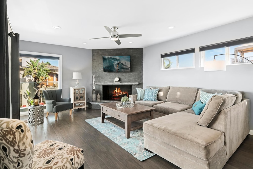 Main upper level living room of front main house, with ocean views, comfy seating, TV, fireplace. Access to front ocean view balcony and outdoor seating.