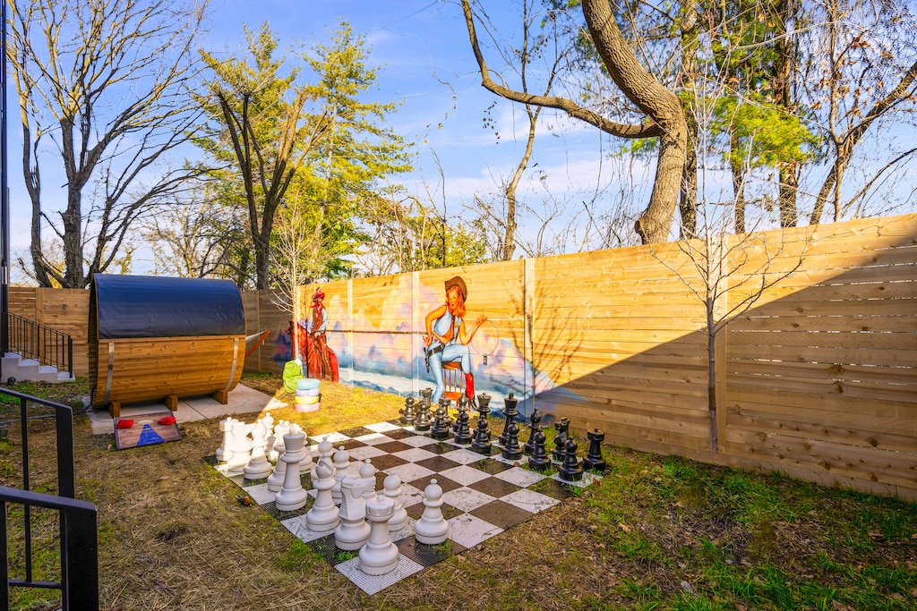 Relax and have fun in this stylish outdoor space featuring a giant chess set and vibrant murals—ideal for family reunions or bachelorette parties, capturing the Nashville vibe and creating lasting memories.