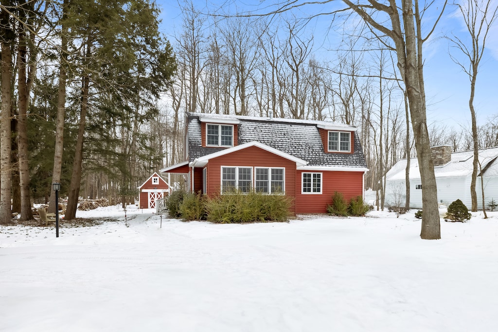 Your cozy escape, framed by snowy trees and nature.