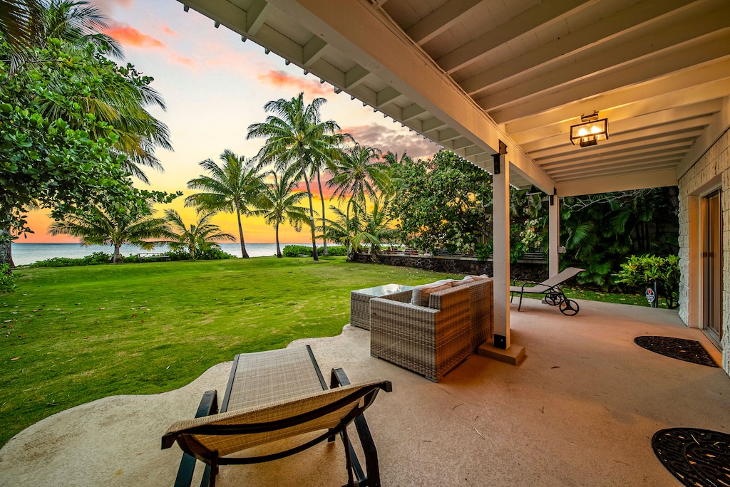 Relax in the lush yard just steps from the sand, perfect for sunset lounging.