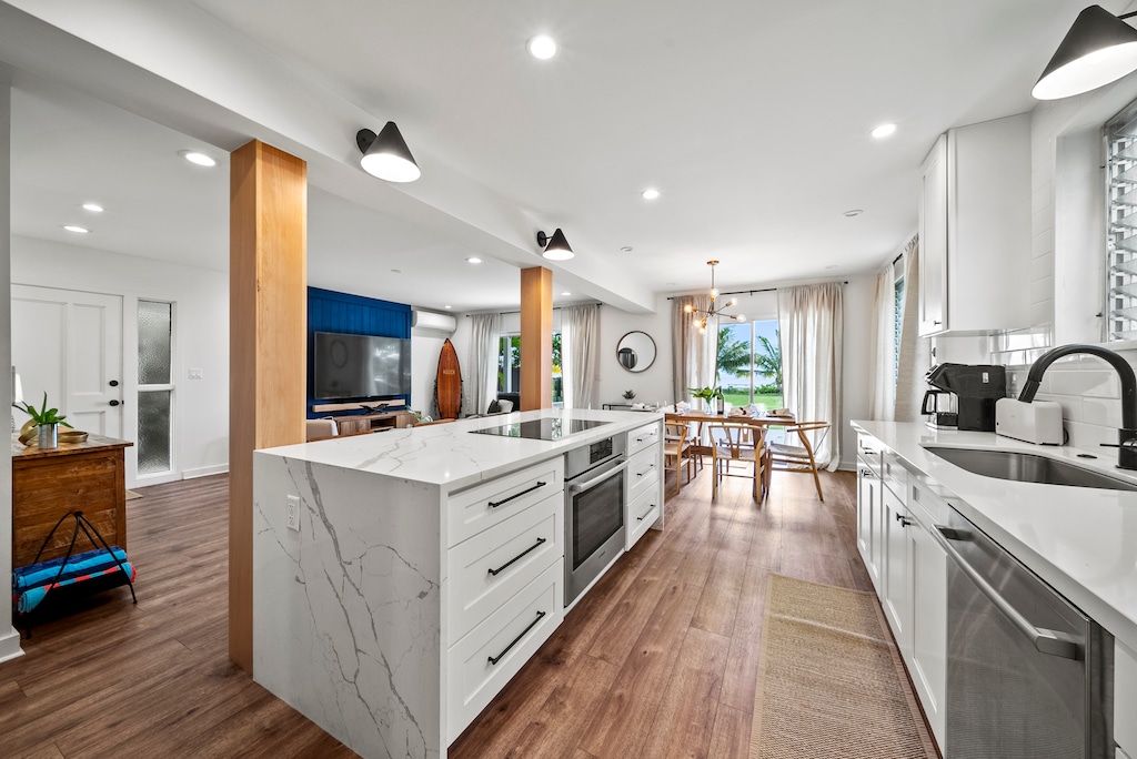 Contemporary kitchen featuring marble countertops, premium appliances, and bar seating — inspiring culinary creations for your stay.