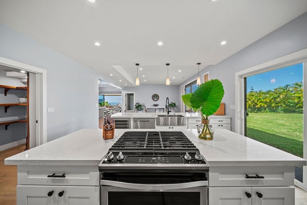 Central kitchen island with gas range anchors entertainer-friendly culinary space.