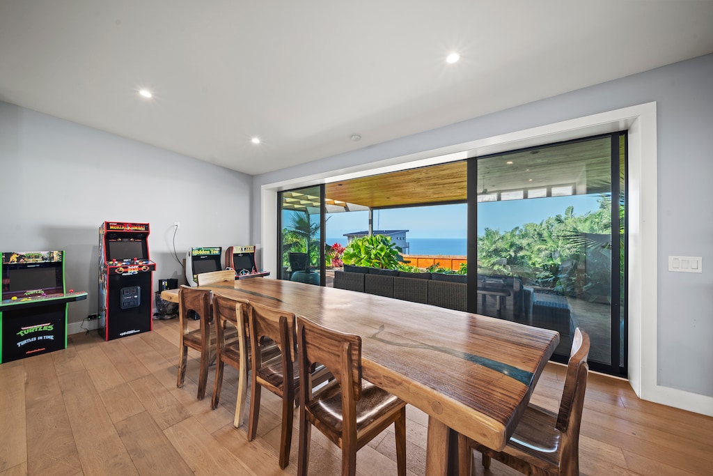 Custom hardwood dining table seats eight beside sweeping North Shore vistas.