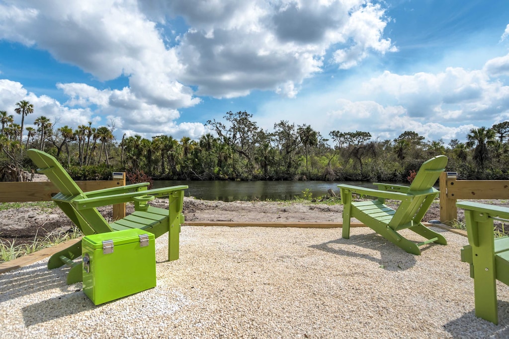 Unwind in these Adirondack chairs with a refreshing drink from the cooler, surrounded by serene nature views.