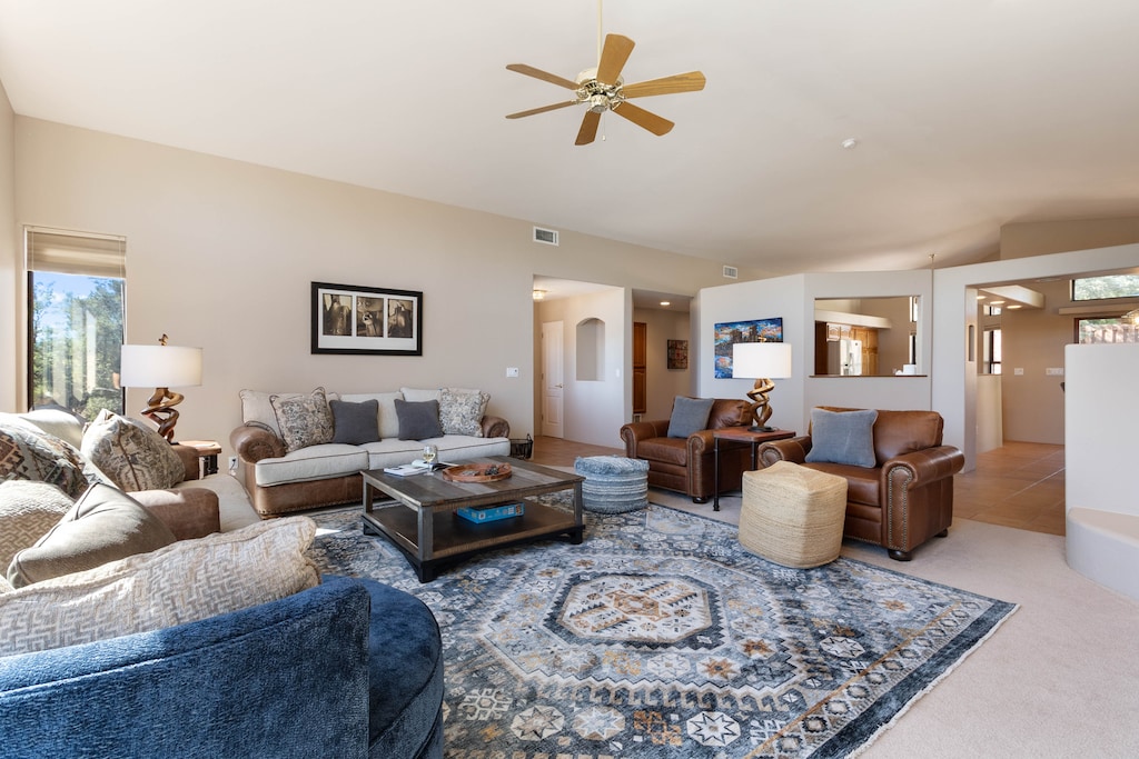 Living room offers cozy furnishings paired with a bright and airy atmosphere