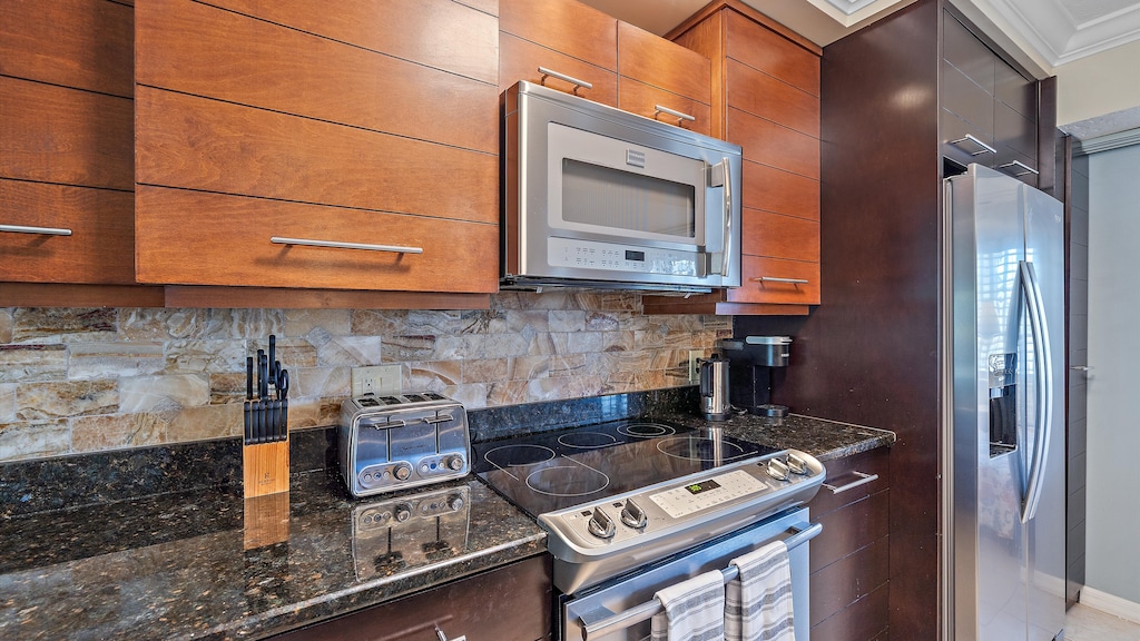Enjoy the high-end finishes and open layout of the kitchen, allowing you to stay connected with your family and guests while prepping meals in your beautiful Sarasota vacation home.