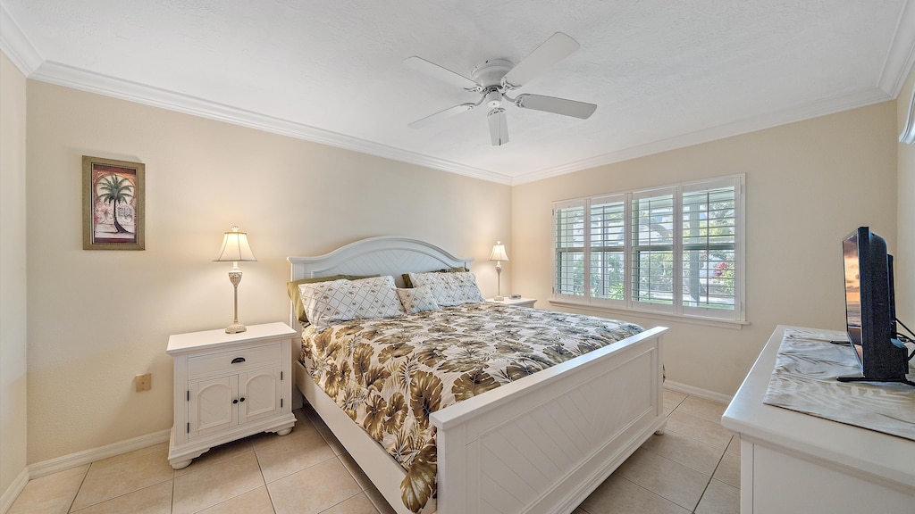 Wake up refreshed in the primary suite with a King bed, a Smart TV, charming coastal furnishings, and peaceful light filtering in through the plantation shutters, perfect for your Sarasota escape.