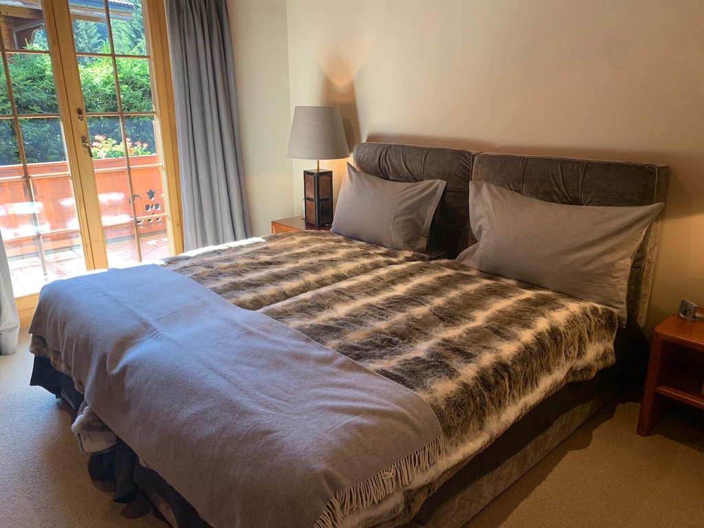 bedroom 1 with a double sized bed and access to the balcony 