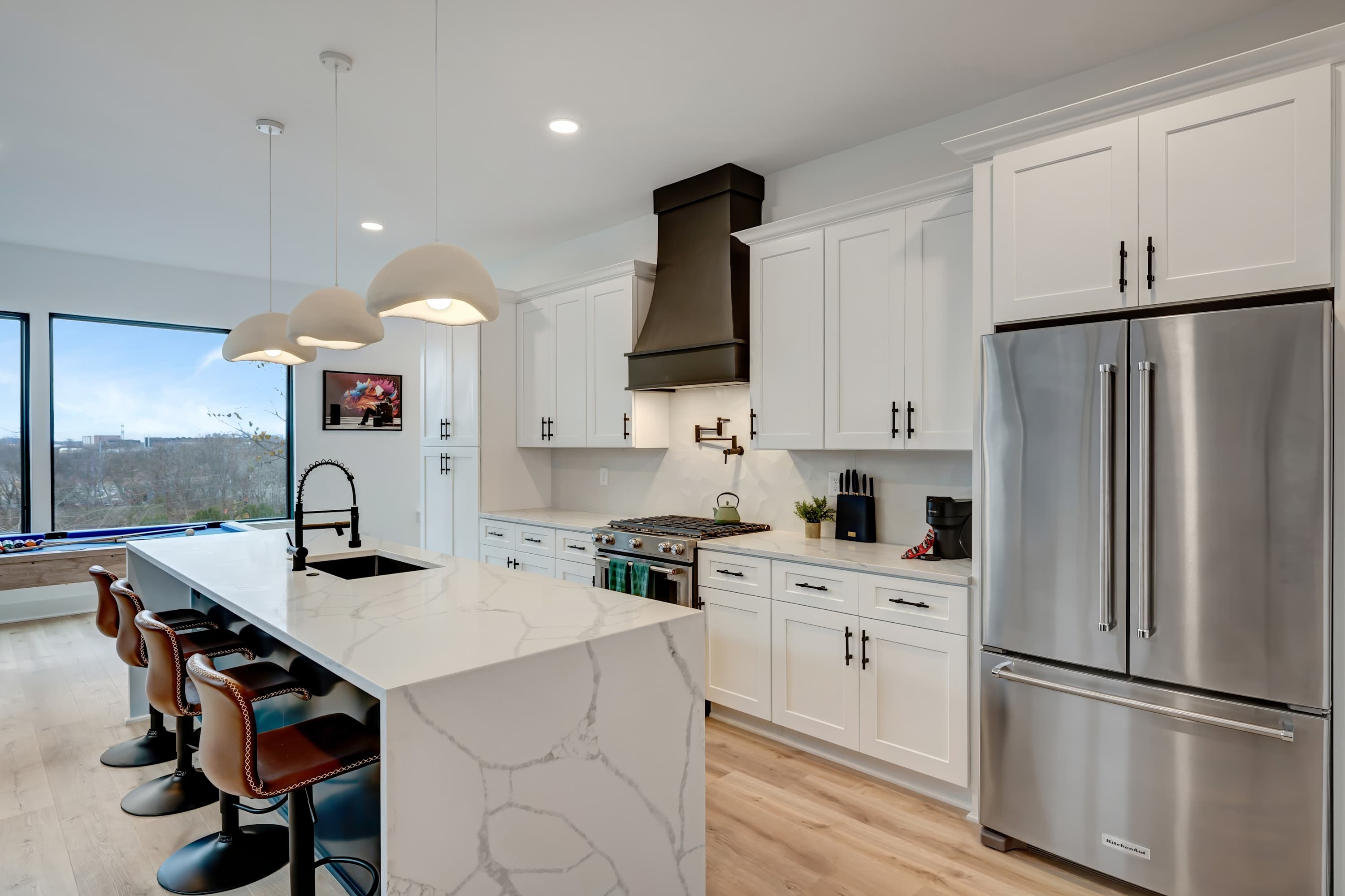 Discover culinary bliss in this chic downtown Nashville kitchen, perfect for hosting dinners and game nights. With marble countertops and modern appliances, it’s an ideal upscale getaway for a bachelorette party or family reunion in Music City.