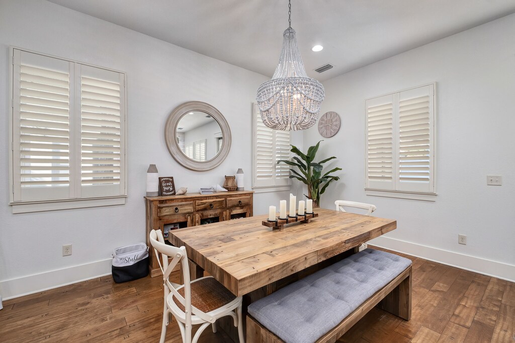 A beautiful wooden table with bench and chair seating.