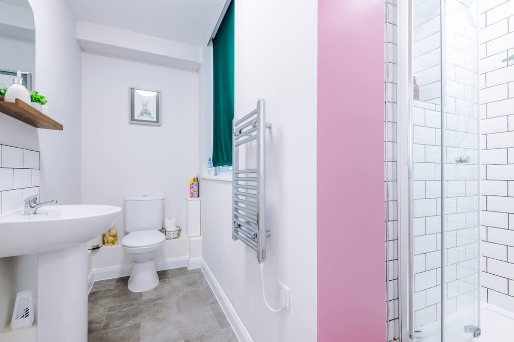 The bathroom benefits from a toilet, sink and shower cubicle.