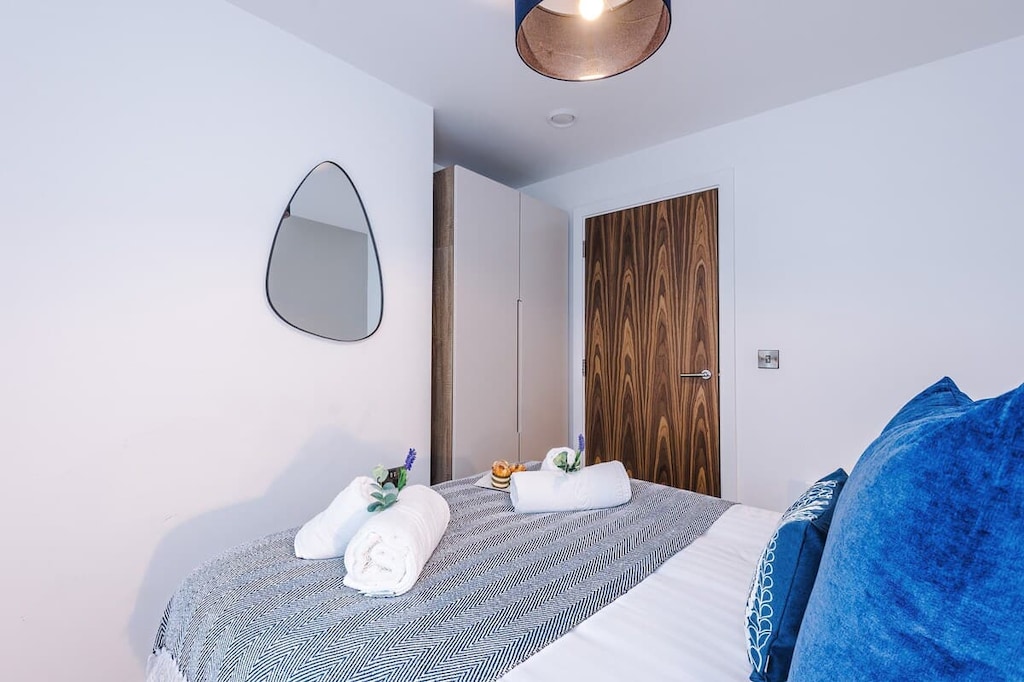 Bedroom 2 benefits from a comfortable double bed, plenty of storage and an en-suite bathroom with a toilet, sink and shower cubicle.
